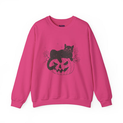 The PUMPKIN CAT SWEATSHIRT is ideal for cat and Halloween fans, featuring a vibrant pink color with a black illustration of a cat relaxing on a carved pumpkin. Surrounded by autumn leaves, this cozy design offers an irresistibly festive and fall-themed appearance.