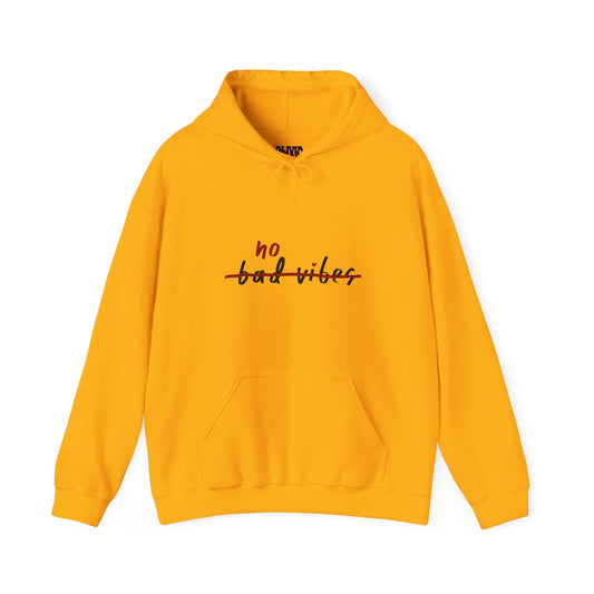 The No Bad Vibes Hoodie, crafted with sustainability in mind, is a bright yellow hoodie featuring a handwritten-style phrase on the chest and includes a convenient front pocket for added style and comfort.